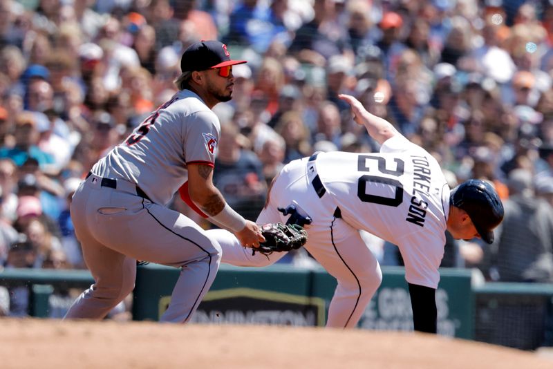 May 25, 2025; Detroit, Michigan, USA; Cleveland Guardians second base Gabriel Arias (13) tags Detroit Tigers first base Spencer Torkelson (20) out in the second inning at Comerica Park. Mandatory Credit: Rick Osentoski-Imagn Images