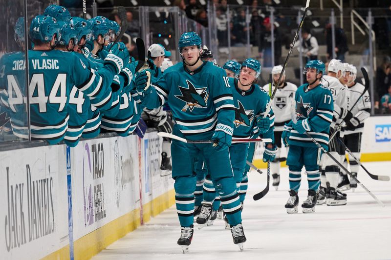 Apr 4, 2024; San Jose, California, USA; San Jose Sharks center Klim Kostin (10) shakes hands with his teammates on the bench after scoring a goal against the Los Angeles Kings during the third period at SAP Center at San Jose. Mandatory Credit: Robert Edwards-USA TODAY Sports