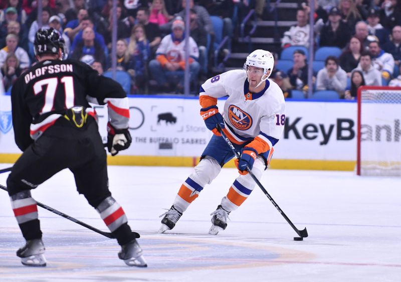 Oct 21, 2023; Buffalo, New York, USA; New York Islanders left wing Pierre Engvall (18) tries to move the puck past Buffalo Sabres left wing Victor Olofsson (71) in the first period at KeyBank Center. Mandatory Credit: Mark Konezny-USA TODAY Sports