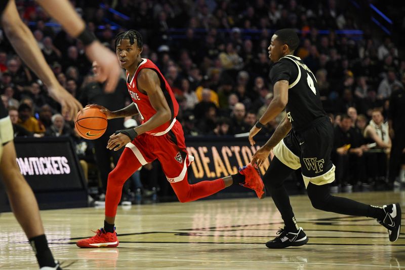 Jan 28, 2023; Winston-Salem, North Carolina, USA;  North Carolina State Wolfpack guard Terquavion Smith (0) drives past Wake Forest Demon Deacons guard Daivien Williamson (4) during the second half at Lawrence Joel Veterans Memorial Coliseum. Mandatory Credit: William Howard-USA TODAY Sports