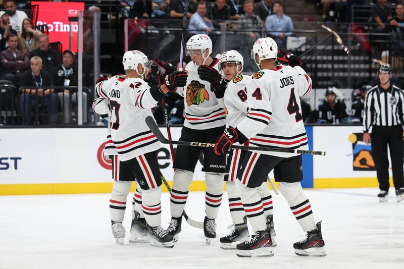 Oct 8, 2024; Salt Lake City, Utah, USA; The Chicago Blackhawks celebrate a goal by Chicago Blackhawks defenseman Alex Vlasic (center) against the Utah Hockey Club during the third period at Delta Center. Mandatory Credit: Rob Gray-Imagn Images