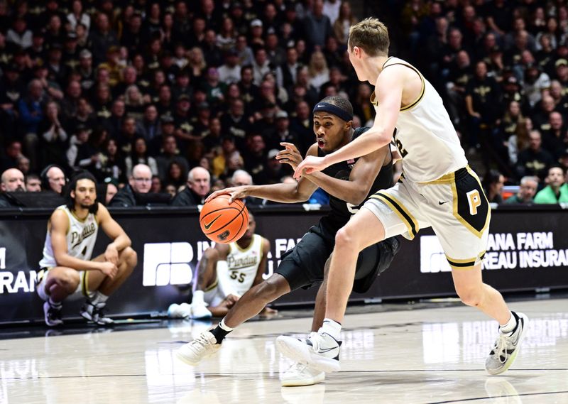 Mar 2, 2024; West Lafayette, Indiana, USA; Michigan State Spartans guard Tre Holloman (5) drives the ball around Purdue Boilermakers guard Fletcher Loyer (2) during the first half at Mackey Arena. Mandatory Credit: Marc Lebryk-USA TODAY Sports