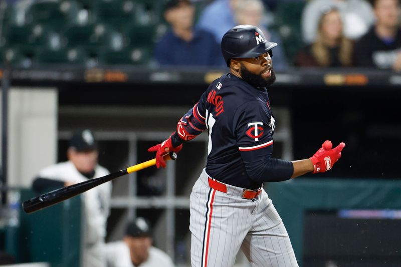 Apr 30, 2024; Chicago, Illinois, USA; Minnesota Twins outfielder Manuel Margot (13) singles against the Chicago White Sox during the ninth inning at Guaranteed Rate Field. Mandatory Credit: Kamil Krzaczynski-USA TODAY Sports