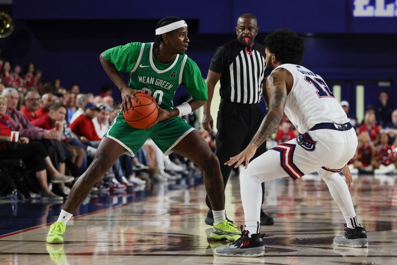 Jan 28, 2024; Boca Raton, Florida, USA; North Texas Mean Green guard John Buggs III (00) protects the basketball from Florida Atlantic Owls guard Jalen Gaffney (12) during the first half at Eleanor R. Baldwin Arena. Mandatory Credit: Sam Navarro-USA TODAY Sports