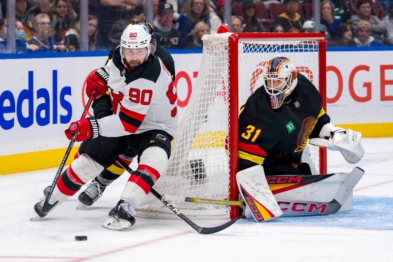 Oct 30, 2024; Vancouver, British Columbia, CAN; Vancouver Canucks goalie Arturs Silovs (31) watches New Jersey Devils forward Tomas Tatar (90) handle the puck during the third period at Rogers Arena. Mandatory Credit: Bob Frid-Imagn Images