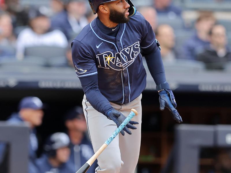 Apr 21, 2024; Bronx, New York, USA; Tampa Bay Rays right fielder Amed Rosario (10) follows through on a two run double against the New York Yankees during the eighth inning at Yankee Stadium. Mandatory Credit: Brad Penner-USA TODAY Sports