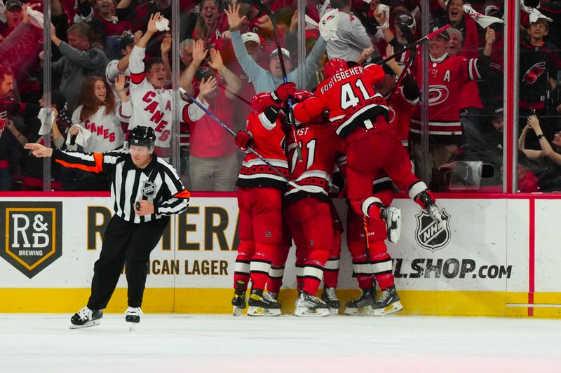 May 11, 2023; Raleigh, North Carolina, USA; Carolina Hurricanes right wing Jesper Fast (71) is congratulated by his teammates after his game winning goal against the New Jersey Devils in overtime in game five of the second round of the 2023 Stanley Cup Playoffs at PNC Arena. Mandatory Credit: James Guillory-USA TODAY Sports