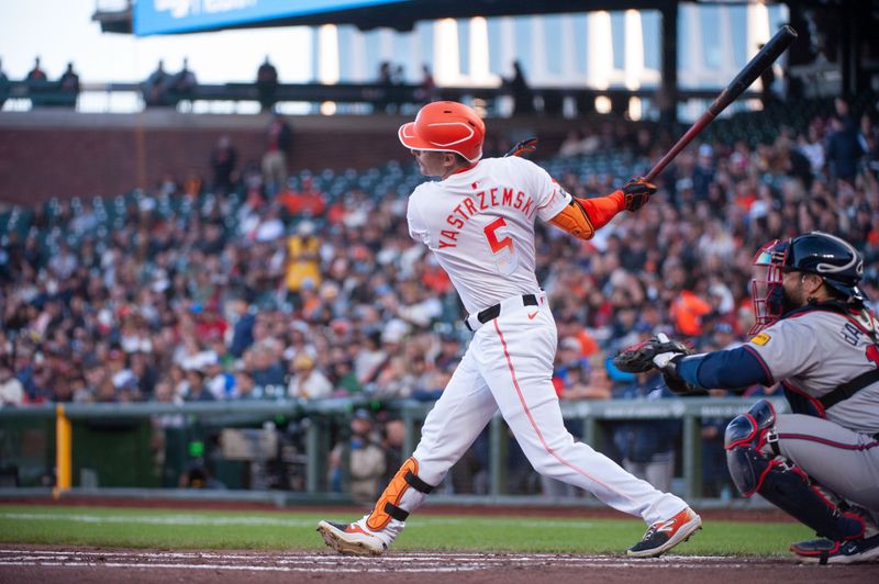 Aug 13, 2024; San Francisco, California, USA;  San Francisco Giants outfielder Mike Yastrzemski (5) hits a single against the Atlanta Braves during the second inning at Oracle Park. Mandatory Credit: Ed Szczepanski-USA TODAY Sports