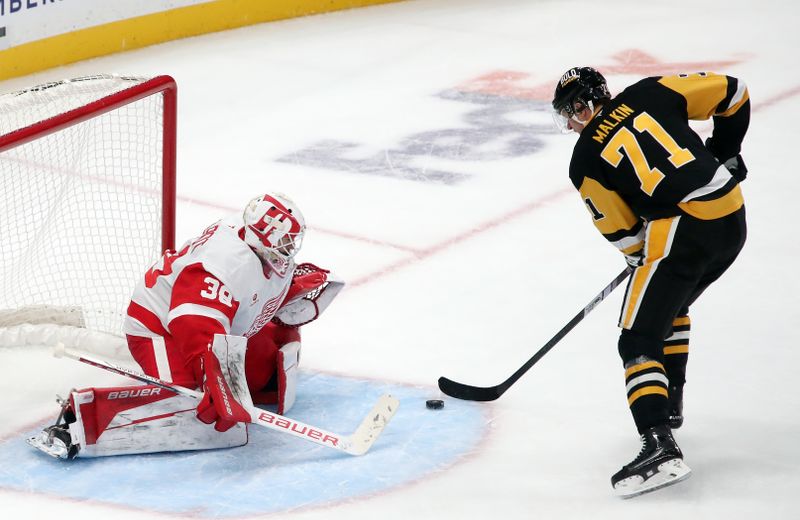 Nov 13, 2024; Pittsburgh, Pennsylvania, USA;  Detroit Red Wings goaltender Cam Talbot (39) defends the net against Pittsburgh Penguins center Evgeni Malkin (71) in overtime at PPG Paints Arena. Mandatory Credit: Charles LeClaire-Imagn Images