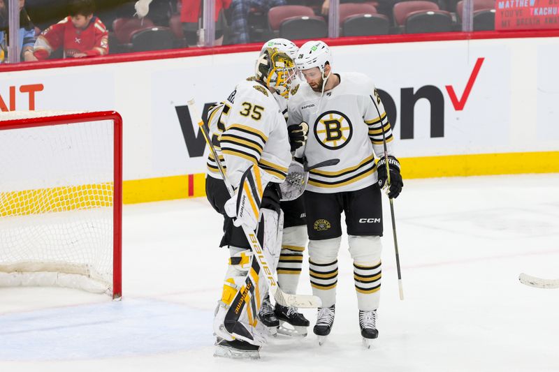 Nov 22, 2023; Sunrise, Florida, USA; Boston Bruins defenseman Derek Forbort (28) and goaltender Linus Ullmark (35) celebrate after winning the game against the Florida Panthers at Amerant Bank Arena. Mandatory Credit: Sam Navarro-USA TODAY Sports