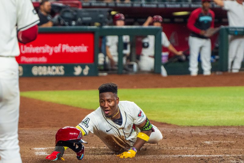 Sep 15, 2024; Phoenix, Arizona, USA; Arizona Diamondbacks infielder Geraldo Perdomo (2) slides past Milwaukee Brewers catcher Eric Haase (13) (not shown) to score in the third inning during  a game against the Milwaukee Brewers at Chase Field. Mandatory Credit: Allan Henry-USA TODAY Sports