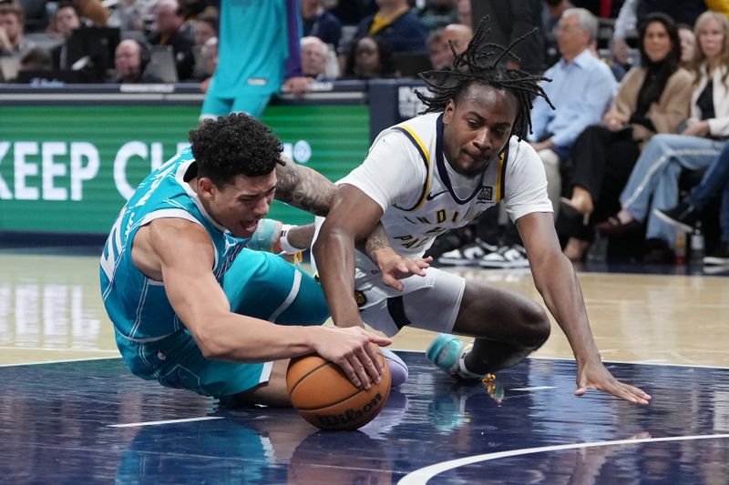 INDIANAPOLIS, INDIANA - OCTOBER 17: K.J. Simpson #25 of the Charlotte Hornets and Tristen Newton #4 of the Indiana Pacers battle for a loose ball in the fourth quarter during a preseason game at Gainbridge Fieldhouse on October 17, 2024 in Indianapolis, Indiana. NOTE TO USER: User expressly acknowledges and agrees that, by downloading and or using this photograph, User is consenting to the terms and conditions of the Getty Images License Agreement. (Photo by Dylan Buell/Getty Images)