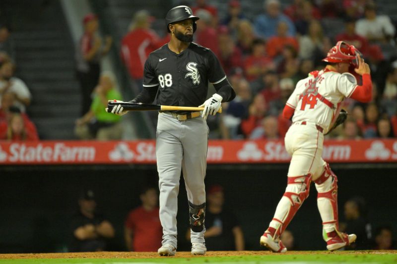 Sep 17, 2024; Anaheim, California, USA;  Chicago White Sox center fielder Luis Robert Jr. (88) returns to the dugout after striking out, leaving two runners on base, in the eighth inning against the Los Angeles Angels at Angel Stadium. Mandatory Credit: Jayne Kamin-Oncea-Imagn Images