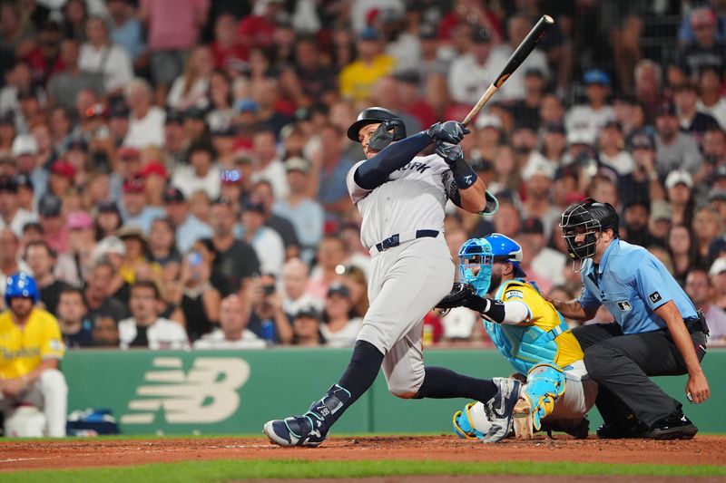 Jul 27, 2024; Boston, Massachusetts, USA; <p><br/></p>New York Yankees designated hitter Aaron Judge (99) hits an RBI single against the Boston Red Sox during the fifth inning at Fenway Park. Mandatory Credit: Gregory Fisher-USA TODAY Sports