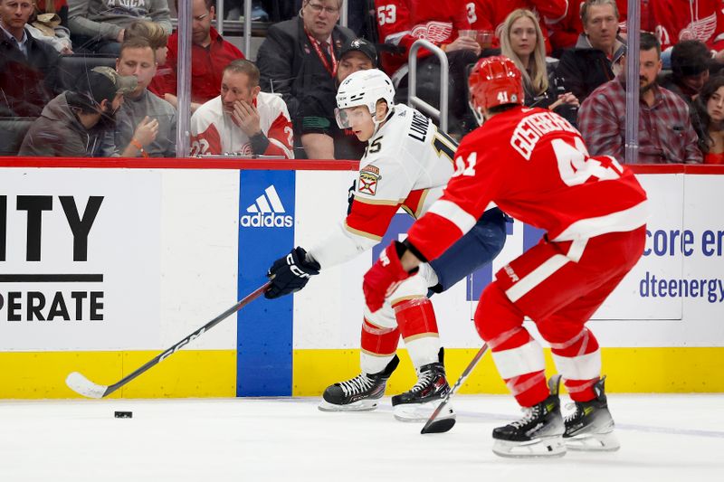 Mar 2, 2024; Detroit, Michigan, USA; Florida Panthers center Anton Lundell (15) skates with the puck defended by Detroit Red Wings defenseman Shayne Gostisbehere (41) in the third period at Little Caesars Arena. Mandatory Credit: Rick Osentoski-USA TODAY Sports