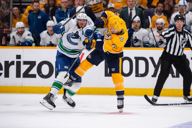 Apr 26, 2024; Nashville, Tennessee, USA; Nashville Predators center Gustav Nyquist (14) and Vancouver Canucks right wing Conor Garland (8) collide during the second period in game three of the first round of the 2024 Stanley Cup Playoffs at Bridgestone Arena. Mandatory Credit: Steve Roberts-USA TODAY Sports