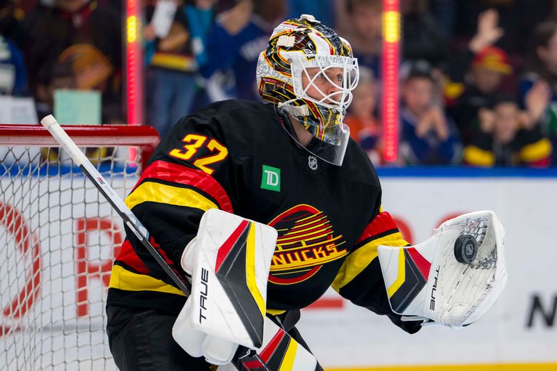 Nov 9, 2024; Vancouver, British Columbia, CAN; Vancouver Canucks goalie Kevin Lankinen (32) makes a save during warm up prior to a game against the Edmonton Oilers at Rogers Arena. Mandatory Credit: Bob Frid-Imagn Images