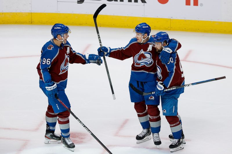 Oct 19, 2023; Denver, Colorado, USA; Colorado Avalanche center Nathan MacKinnon (29) celebrates his goal with right wing Mikko Rantanen (96) and left wing Tomas Tatar (90) in the third period against the Chicago Blackhawks at Ball Arena. Mandatory Credit: Isaiah J. Downing-USA TODAY Sports