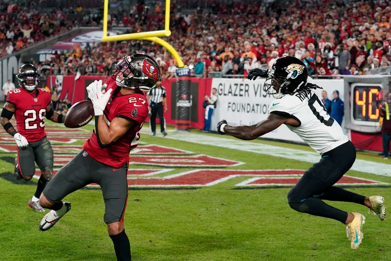 Tampa Bay Buccaneers cornerback Zyon McCollum (27) breaks up a pass but can't make the interception intended for Jacksonville Jaguars wide receiver Calvin Ridley (0) during the second half of an NFL football game Sunday, Dec. 24, 2023, in Tampa, Fla. (AP Photo/Chris O'Meara)