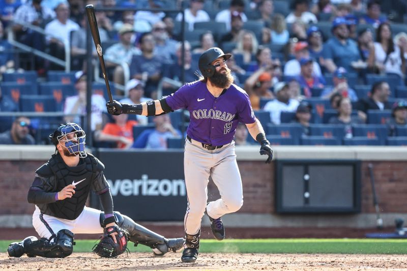 Jul 13, 2024; New York City, New York, USA;  Colorado Rockies designated hitter Charlie Blackmon (19) hits a two run home run in the fifth inning against the New York Mets at Citi Field. Mandatory Credit: Wendell Cruz-USA TODAY Sports