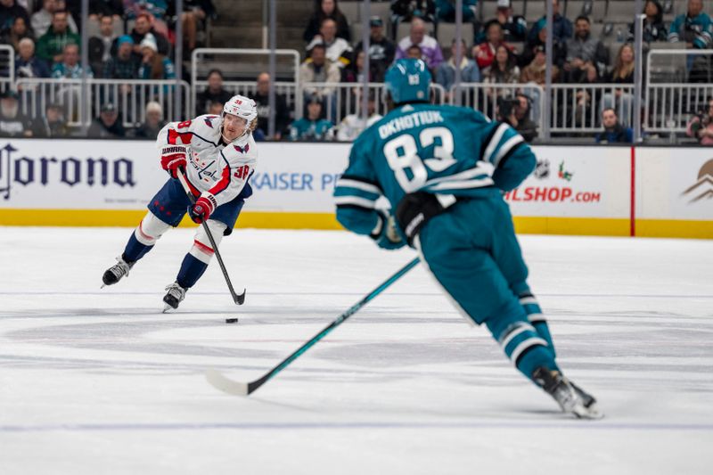 Nov 27, 2023; San Jose, California, USA; Washington Capitals defenseman Rasmus Sandin (38) passes the puck against San Jose Sharks defenseman Nikita Okhotiuk (83) during the first period at SAP Center at San Jose. Mandatory Credit: Neville E. Guard-USA TODAY Sports