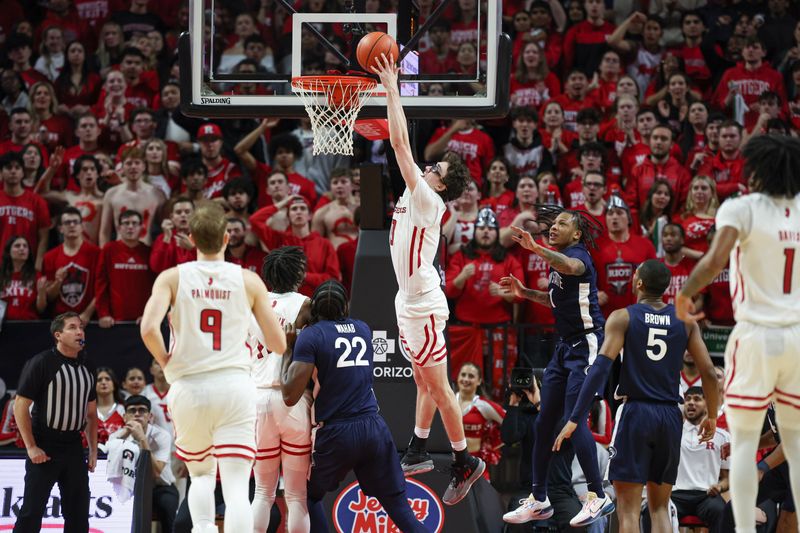 Jan 31, 2024; Piscataway, New Jersey, USA; Rutgers Scarlet Knights guard Gavin Griffiths (10) dunks the ball during the first half in front of Penn State Nittany Lions guard Ace Baldwin Jr. (1) at Jersey Mike's Arena. Mandatory Credit: Vincent Carchietta-USA TODAY Sports