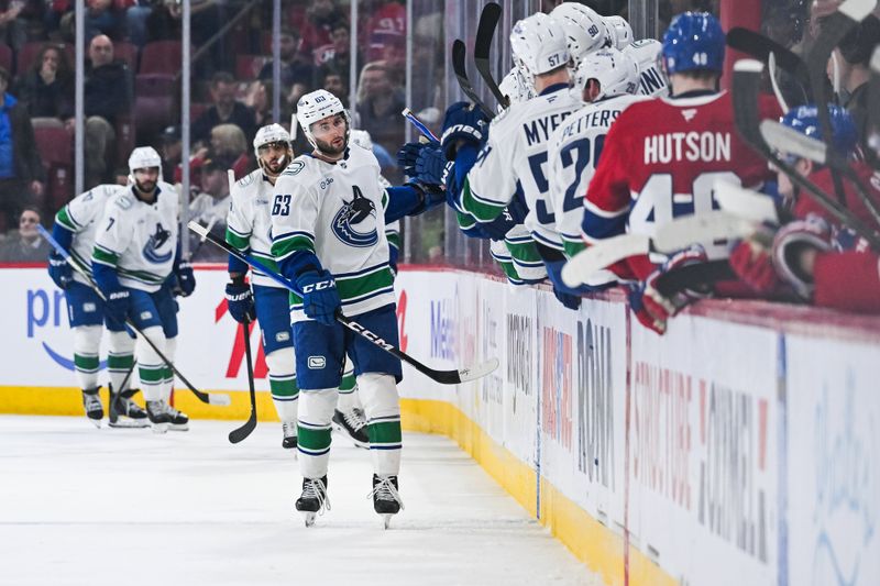Jan 12, 2026; Montreal, Quebec, CAN; Vancouver Canucks center Max Sasson (63) celebrates with his teammates at the bench his goal against the Montreal Canadiens during the second period at Bell Centre. Mandatory Credit: David Kirouac-Imagn Images