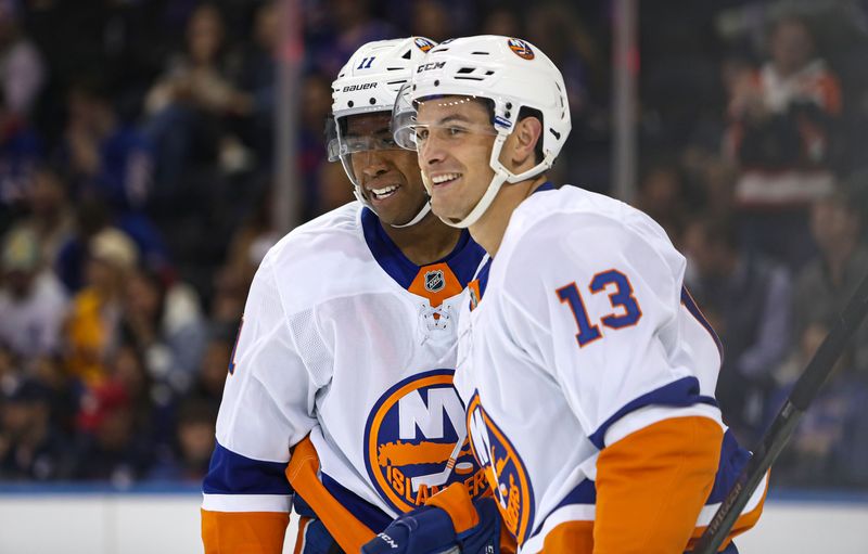 Sep 24, 2024; New York, New York, USA; New York Islanders center Mathew Barzal (13) celebrates his goal with left wing Anthony Duclair (11) during the second period against the New York Rangers at Madison Square Garden. Mandatory Credit: Danny Wild-Imagn Images