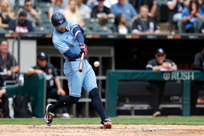 May 27, 2024; Chicago, Illinois, USA; Toronto Blue Jays outfielder George Springer (4) hits a two-run home run against the Chicago White Sox during the second inning at Guaranteed Rate Field. Mandatory Credit: Kamil Krzaczynski-USA TODAY Sports