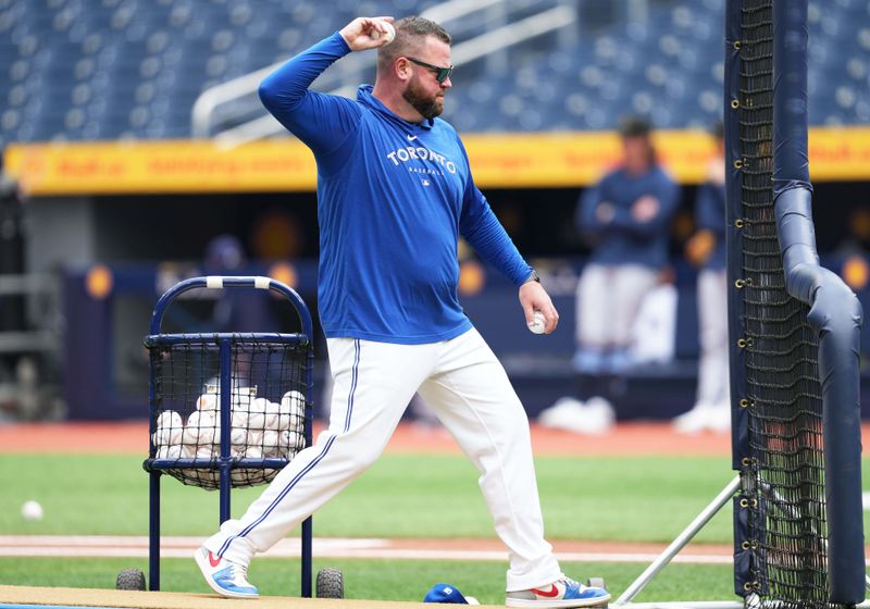 May 18, 2024; Toronto, Ontario, CAN; Toronto Blue Jays manager John Schneider (14) throws balls during batting practice before a game against the Tampa Bay Rays at Rogers Centre. Mandatory Credit: Nick Turchiaro-USA TODAY Sports