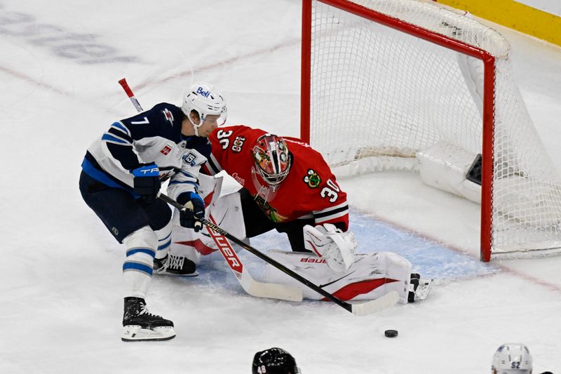 Jan 19, 2026; Chicago, Illinois, USA;  Winnipeg Jets center Vladislav Namestnikov (7) shoots the puck against Chicago Blackhawks goaltender Spencer Knight (30) during the first period at United Center. Mandatory Credit: Matt Marton-Imagn Images
