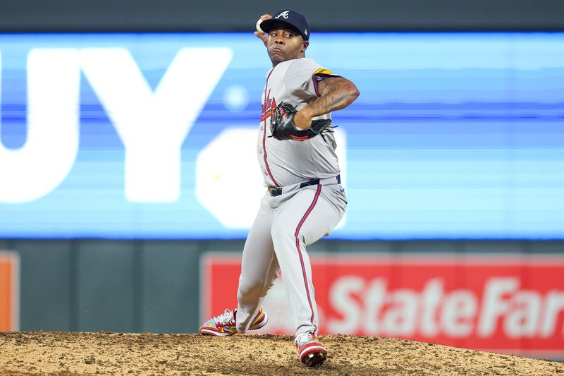 Aug 28, 2024; Minneapolis, Minnesota, USA; Atlanta Braves relief pitcher Raisel Iglesias (26) delivers a pitch against Minnesota Twins during the ninth inning at Target Field. Mandatory Credit: Matt Krohn-USA TODAY Sports