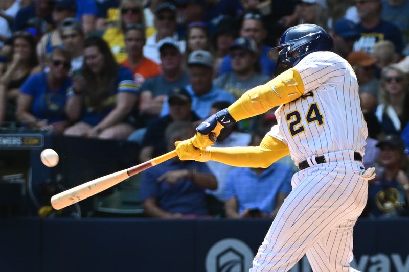 May 28, 2023; Milwaukee, Wisconsin, USA;  Milwaukee Brewers catcher William Contreras (24) hits a two-run home run in the second inning against the San Francisco Giants at American Family Field. Mandatory Credit: Benny Sieu-USA TODAY Sports