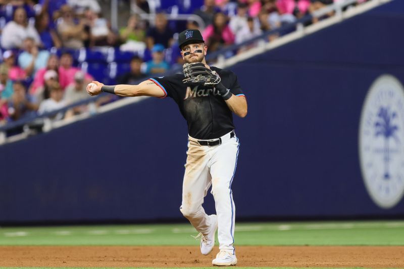 Aug 23, 2024; Miami, Florida, USA; Miami Marlins third baseman Connor Norby (24) throws to first base to retire Chicago Cubs first baseman Michael Busch (not pictured) during the seventh inning at loanDepot Park. Mandatory Credit: Sam Navarro-USA TODAY Sports