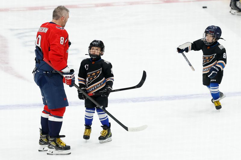 Nov 26, 2025; Washington, District of Columbia, USA; Washington Capitals left wing Alex Ovechkin (8) skates on the ice alongside his two sons Sergei (M) and Ilya (R) during warmups prior to the Capitals game against the Winnipeg Jets at Capital One Arena. Mandatory Credit: Geoff Burke-Imagn Images