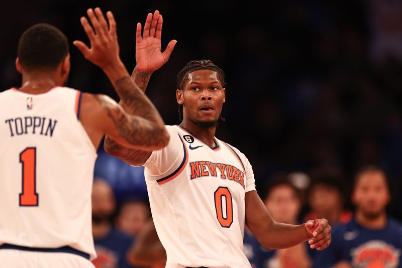 NEW YORK, NEW YORK - OCTOBER 21: Cam Reddish #0 of the New York Knicks high fives Obi Toppin #1 of the New York Knicks during the second quarter of the game against the Detroit Pistons at Madison Square Garden on October 21, 2022 in New York City. NOTE TO USER: User expressly acknowledges and agrees that,  by downloading and or using this photograph,  User is consenting to the terms and conditions of the Getty Images License Agreement. (Photo by Dustin Satloff/Getty Images)