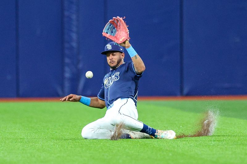 Apr 3, 2024; St. Petersburg, Florida, USA;  Tampa Bay Rays center fielder Jose Siri (22) dives for a fly ball against the Texas Rangers in the third inning at Tropicana Field. Mandatory Credit: Nathan Ray Seebeck-USA TODAY Sports