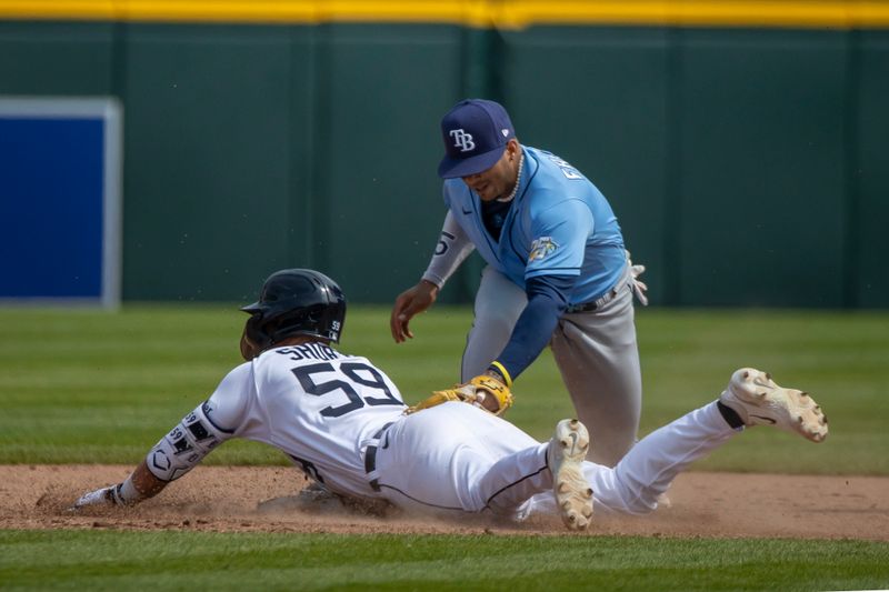 Aug 5, 2023; Detroit, Michigan, USA; Detroit Tigers second baseman Zack Short (59) slides head first into second base after hitting a double and beats the tag by Tampa Bay Rays shortstop Wander Franco (5) at Comerica Park. Mandatory Credit: David Reginek-USA TODAY Sports