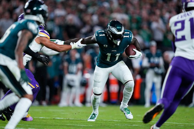 Philadelphia Eagles wide receiver A.J. Brown (11) runs with the ball during the first half of an NFL football game against the Minnesota Vikings on Thursday, Sept. 14, 2023, in Philadelphia. (AP Photo/Matt Rourke)