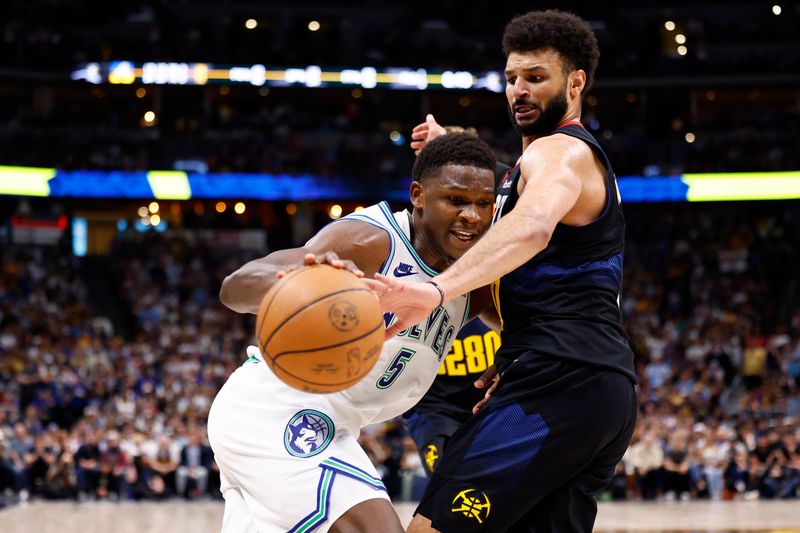 DENVER, COLORADO - MAY 19: Anthony Edwards #5 of the Minnesota Timberwolves drives to the basket against Jamal Murray #27 of the Denver Nuggets during the fourth quarter in Game Seven of the Western Conference Second Round Playoffs at Ball Arena on May 19, 2024 in Denver, Colorado. NOTE TO USER: User expressly acknowledges and agrees that, by downloading and or using this photograph, User is consenting to the terms and conditions of the Getty Images License Agreement. (Photo by C. Morgan Engel/Getty Images)