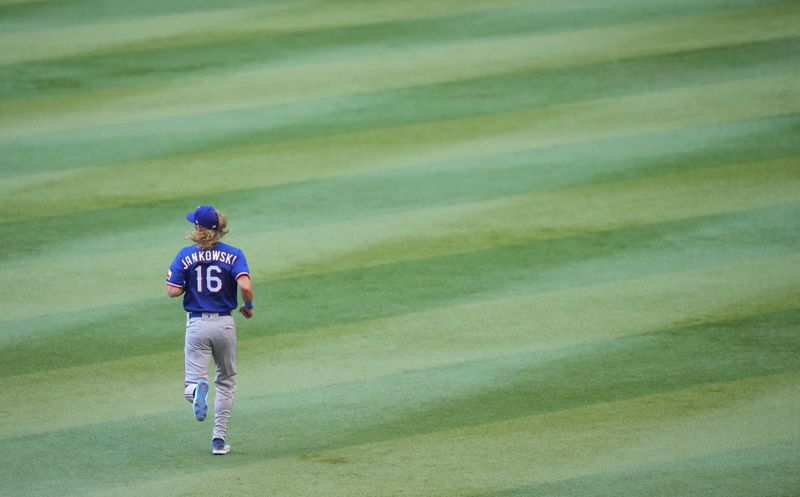 Nov 1, 2023; Phoenix, AZ, USA; Texas Rangers left fielder Travis Jankowski (16) warms up before the game against  Arizona Diamondbacks in game five of the 2023 World Series at Chase Field. Mandatory Credit: Joe Camporeale-USA TODAY Sports