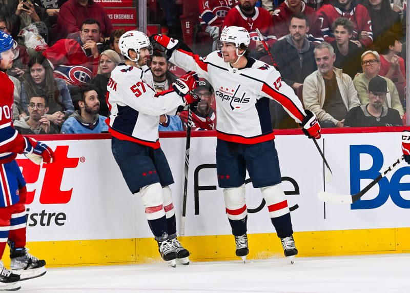 Oct 21, 2023; Montreal, Quebec, CAN; Washington Capitals center Dylan Strome (17) celebrates his first goal of the game against the Montreal Canadiens with defenseman Trevor van Riemsdyk (57) during the third period at Bell Centre. Mandatory Credit: David Kirouac-USA TODAY Sports