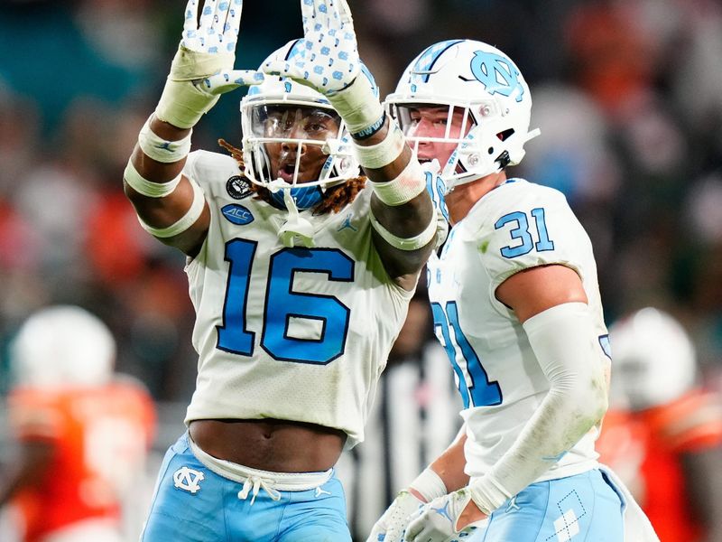 Oct 8, 2022; Miami Gardens, Florida, USA; North Carolina Tar Heels defensive back DeAndre Boykins (16) celebrates his interception by doing a Miami    U    sign against the Miami Hurricanes during the second half at Hard Rock Stadium. Mandatory Credit: Rich Storry-USA TODAY Sports