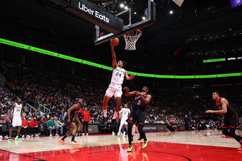 TORONTO, CANADA - MARCH 23:  Devin Vassell #24 of the San Antonio Spurs drives to the basket during the game against the Toronto Raptors on March 23, 2025 at the Scotiabank Arena in Toronto, Ontario, Canada.  NOTE TO USER: User expressly acknowledges and agrees that, by downloading and or using this Photograph, user is consenting to the terms and conditions of the Getty Images License Agreement.  Mandatory Copyright Notice: Copyright 2025 NBAE (Photo by Vaughn Ridley/NBAE via Getty Images)