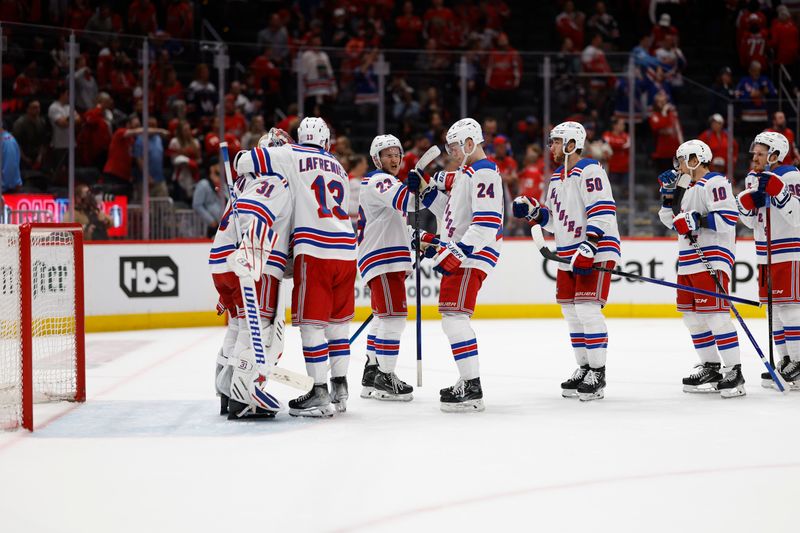 Apr 28, 2024; Washington, District of Columbia, USA; New York Rangers players celebrate after their game against the Washington Capitals in game four of the first round of the 2024 Stanley Cup Playoffs at Capital One Arena. Mandatory Credit: Geoff Burke-USA TODAY Sports