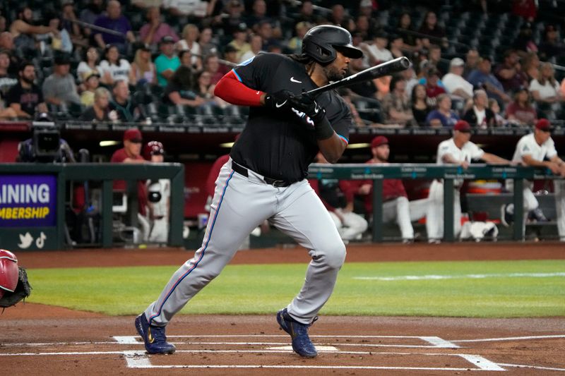 May 24, 2024; Phoenix, Arizona, USA; Miami Marlins first base Josh Bell (9) hits against the Arizona Diamondbacks in the first inning at Chase Field. Mandatory Credit: Rick Scuteri-USA TODAY Sports