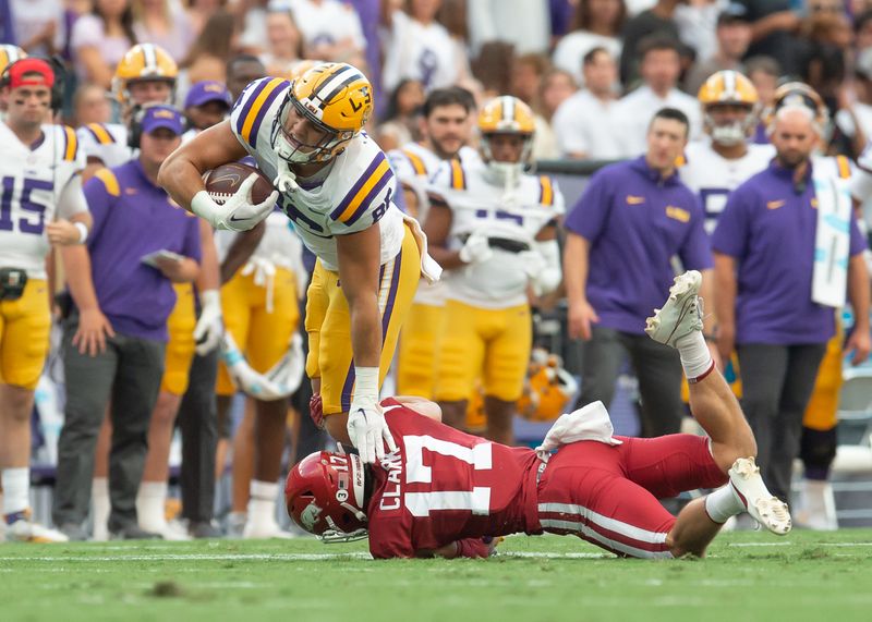 Sep 23, 2023; Baton Rouge, Louisiana, USA; Arkansas Razorbacks defensive back Hudson Clark (17) tackles LSU Tigers tight end Mason Taylor (86)  during the game at Tiger Stadium. Mandatory Credit: Scott Clause-USA TODAY Sports