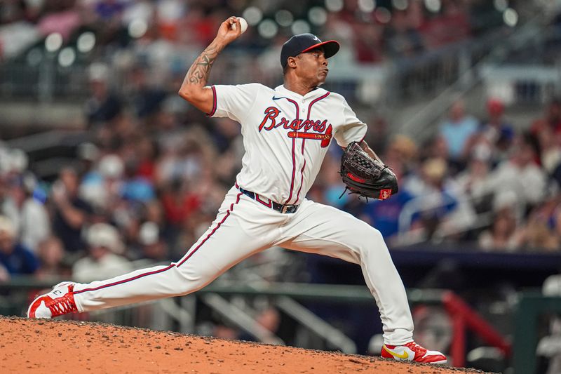 Jul 3, 2024; Cumberland, Georgia, USA; Atlanta Braves relief pitcher Raisel Iglesias (26) pitches against the San Francisco Giants during the ninth inning at Truist Park. Mandatory Credit: Dale Zanine-USA TODAY Sports