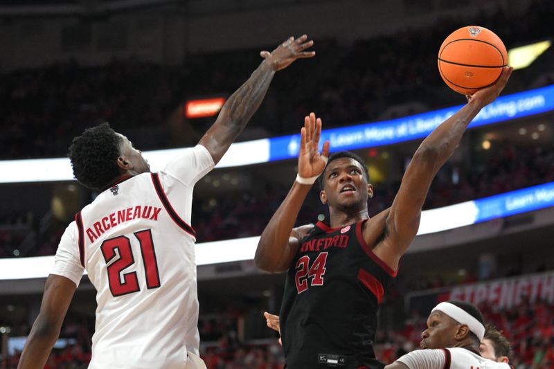 Mar 7, 2026; Raleigh, North Carolina, USA;  Stanford Cardinal forward Jaylen Thompson (24) lays the ball up against NC State Wolfpack guard Terrance Arceneaux (21) during the second half at Lenovo Center. Mandatory Credit: Zachary Taft-Imagn Images