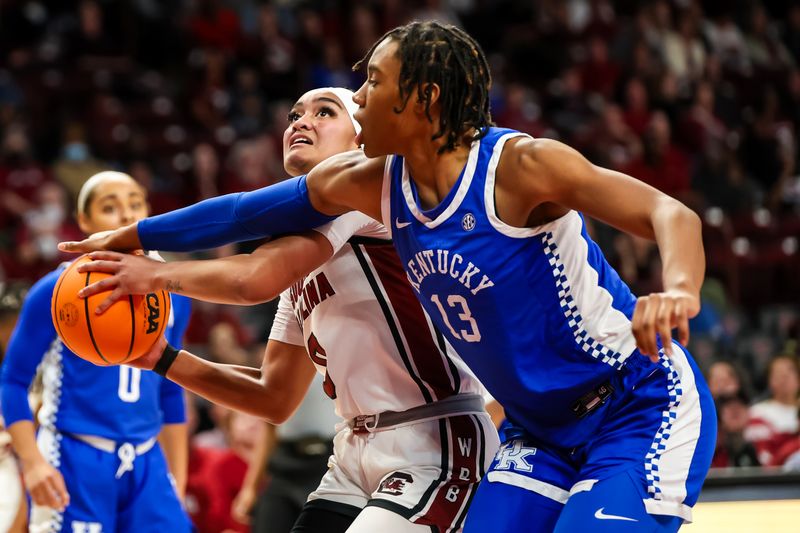 Jan 15, 2024; Columbia, South Carolina, USA; South Carolina Gamecocks guard Te-Hina Paopao (0) attempts to shoot around Kentucky Wildcats forward Ajae Petty (13) in the second half at Colonial Life Arena. Mandatory Credit: Jeff Blake-USA TODAY Sports